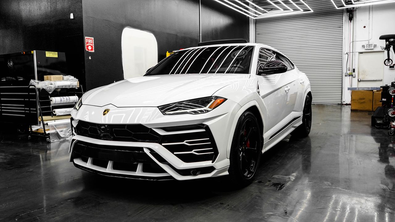 services-01 White luxury SUV in a sleek garage, showcasing modern design and premium automotive style.